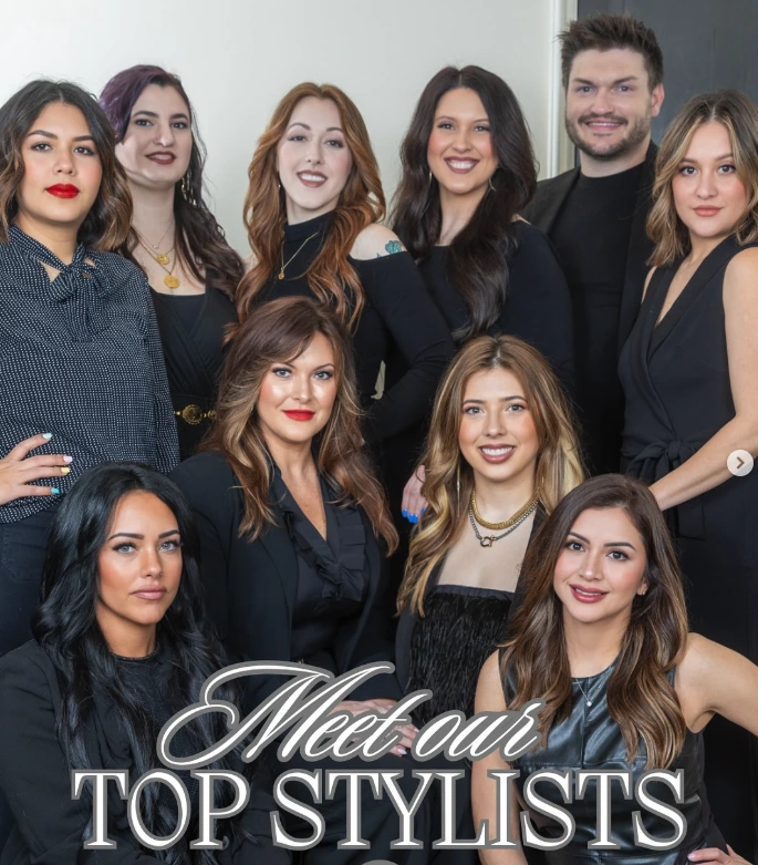 A group of nine salon stylists posing for a portrait, with the text “Meet our TOP STYLISTS” overlaid at the bottom. - Tonya Jones SalonSpa| Birmingham, AL